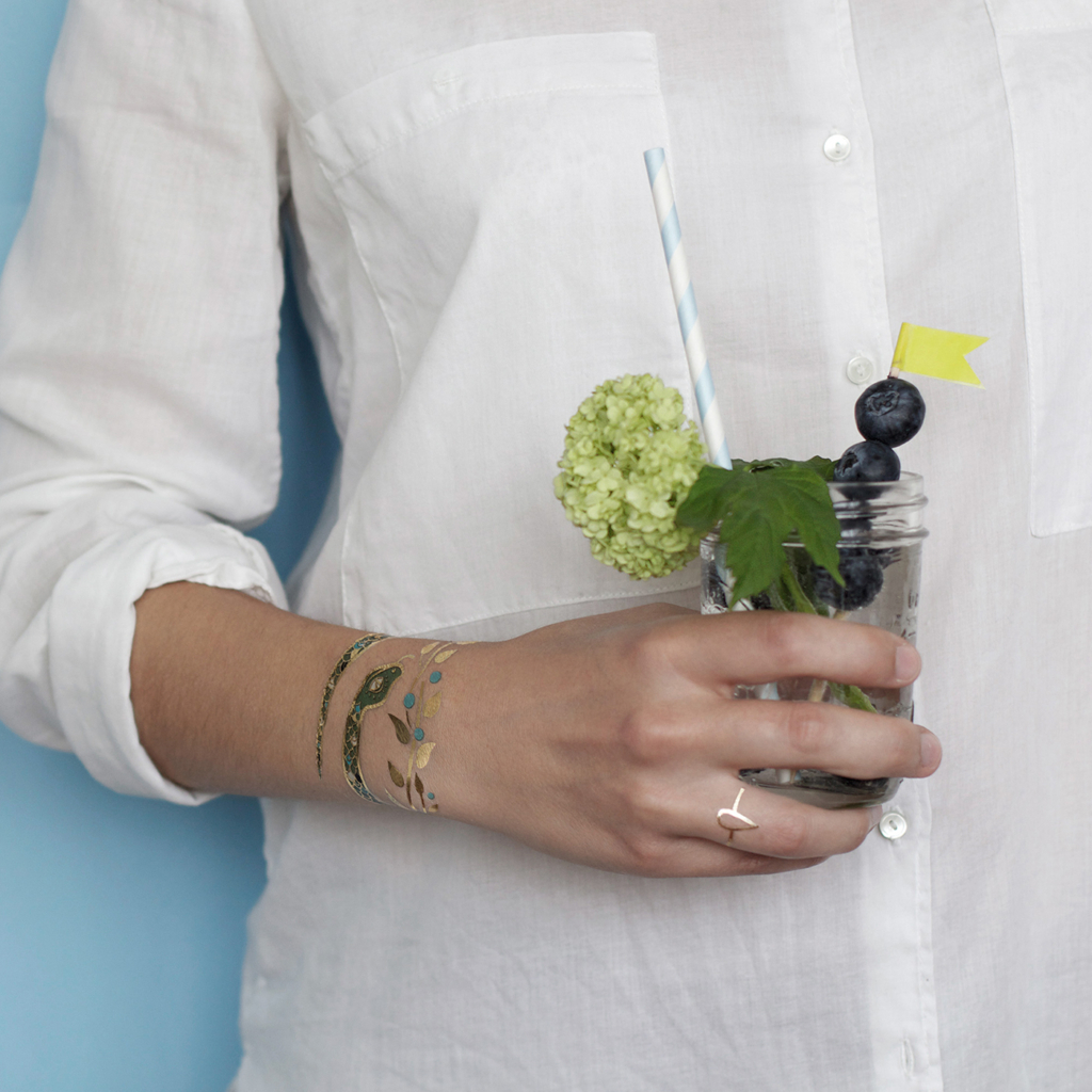 temporary tattoo by artist Anne-Claire snake bracelet applied on a woman's wrist