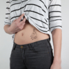 Temporary black tattoo woman with phone from the board "violence and love" applied on the belly of a woman