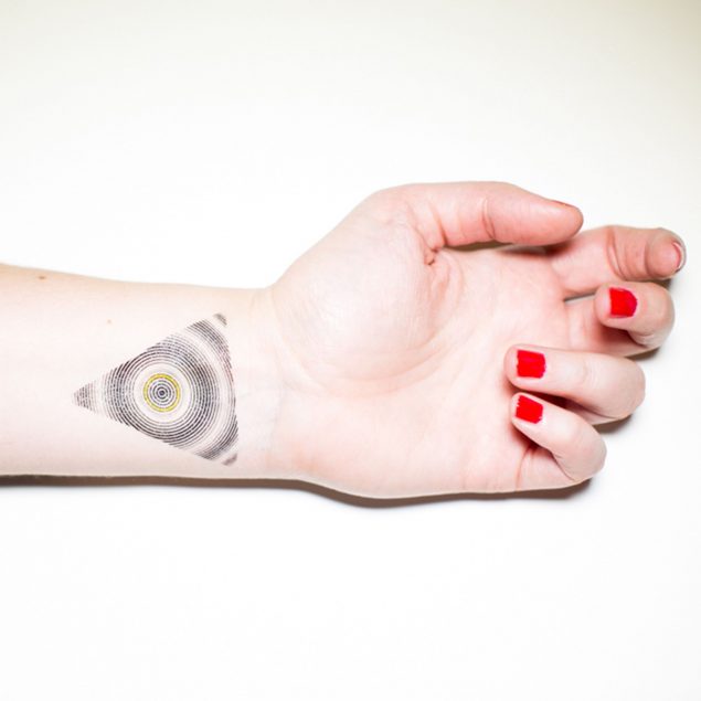 tatouage temporaire triangle noir de la planche "illusion" appliqué sur le poignet d'une femme
